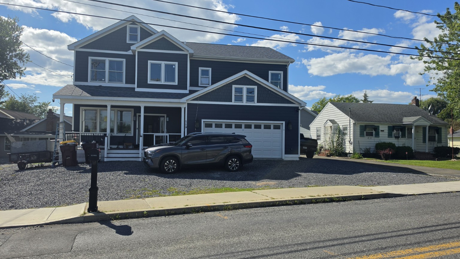 Two-story blue house with white trim and attached garage